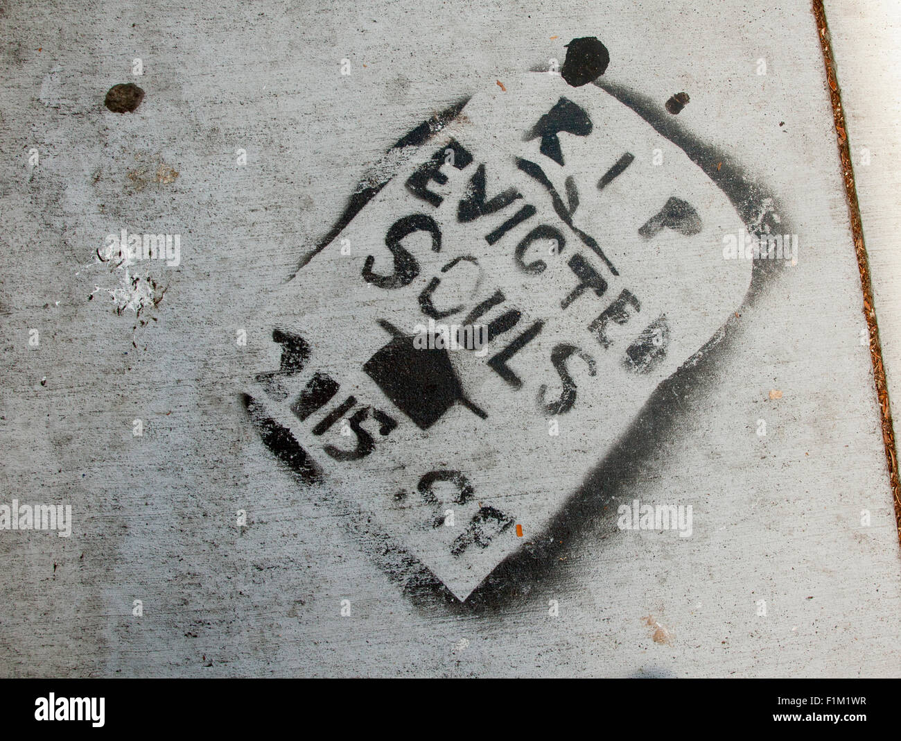 Sidewalk graffiti off of 24th St in San Francisco: 'RIP Evicted Souls, 2015 SF' Stock Photo