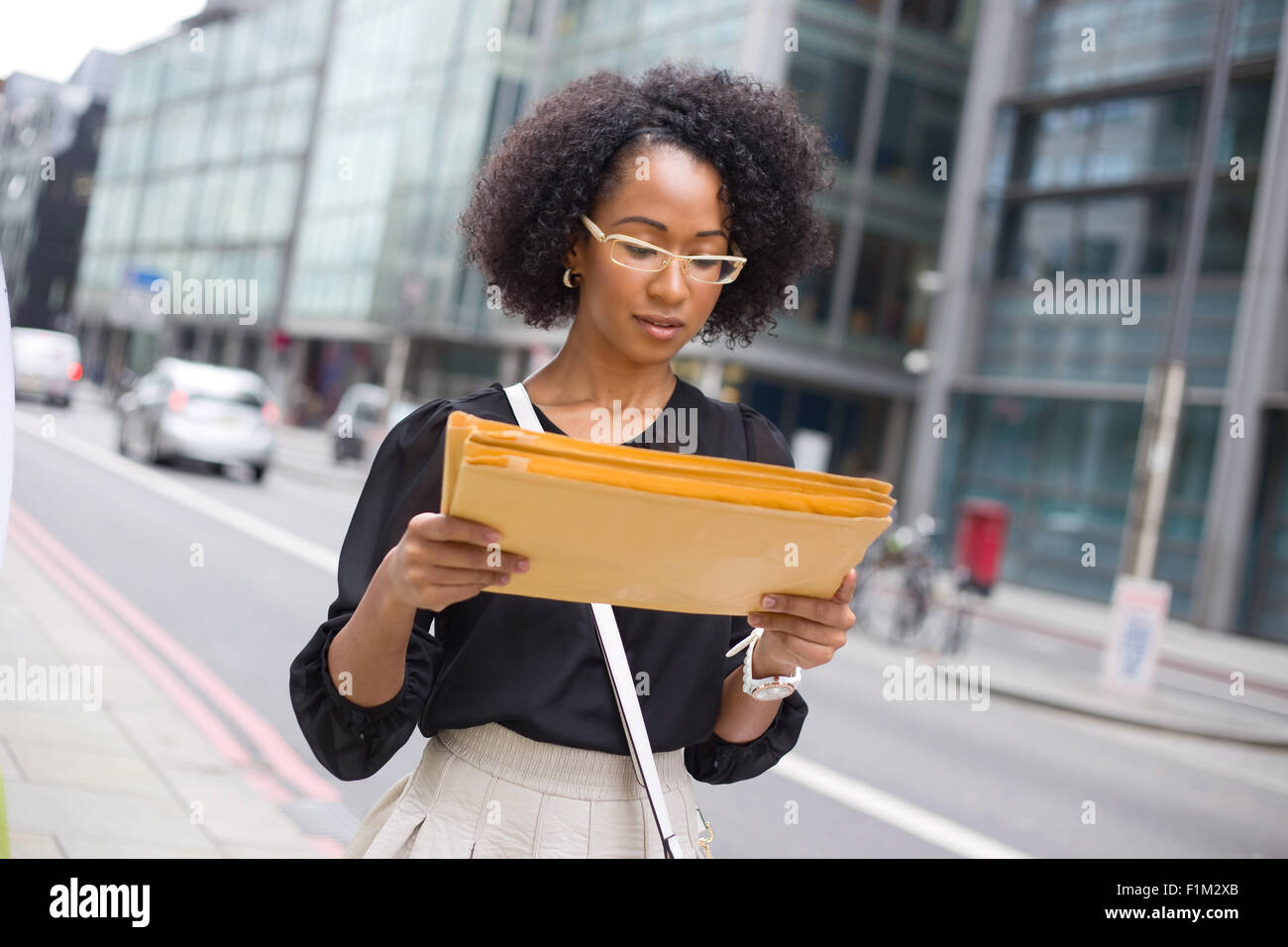 young office girl reading the address on envelopes Stock Photo Alamy
