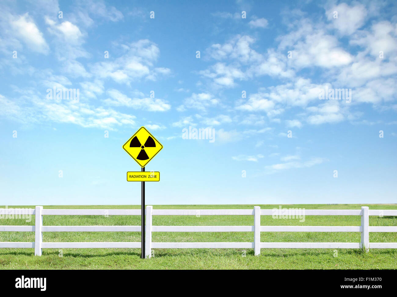nuclear radiation warning symbol with blue sky Stock Photo