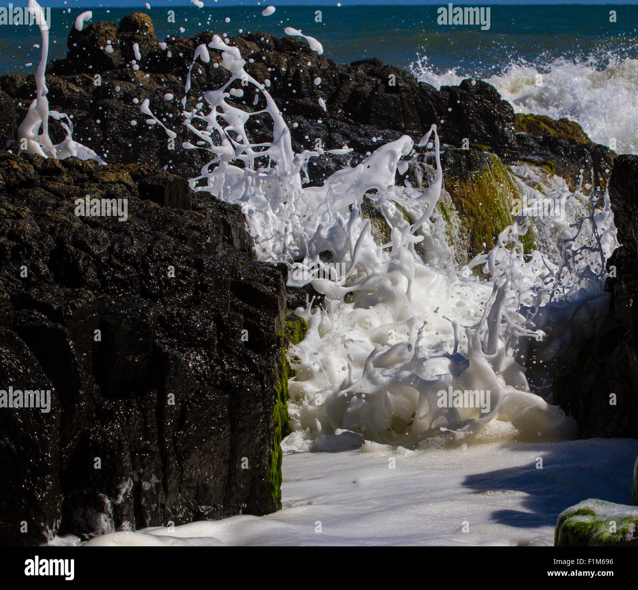 Waves breaking down a narrow channel. Stock Photo