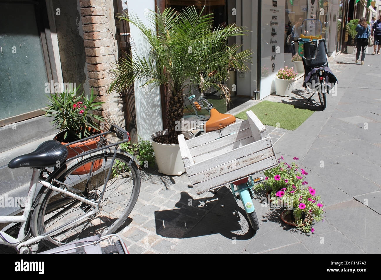 MILAN, ITALY - JUNE 24, 2015: The Italian cargo bicycles on the street of old Milan. The Italian bicycles are considered the bes Stock Photo