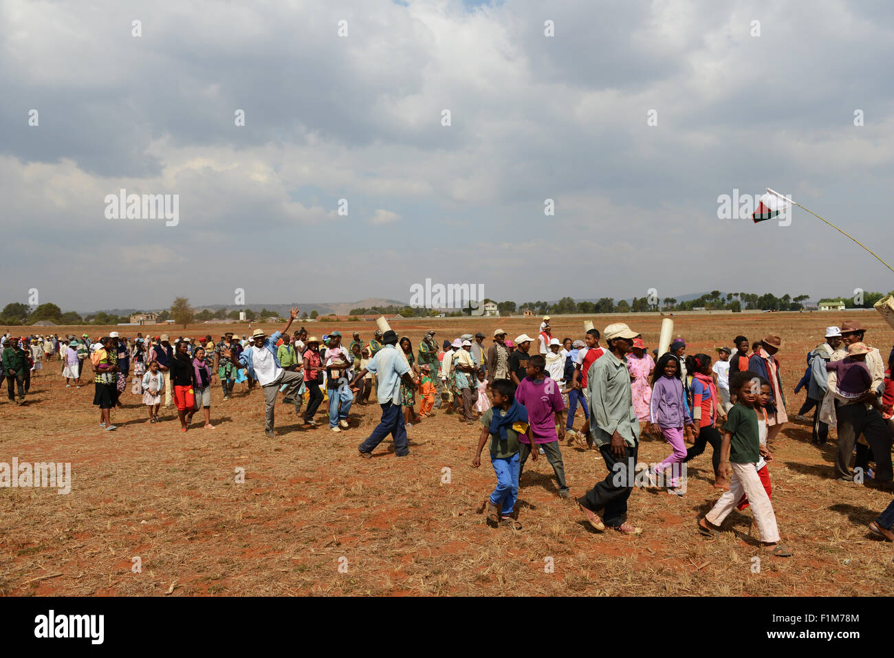 A procession to the tomb. Malagasy people holding mats which will cover the corpses when they are taken out. Stock Photo