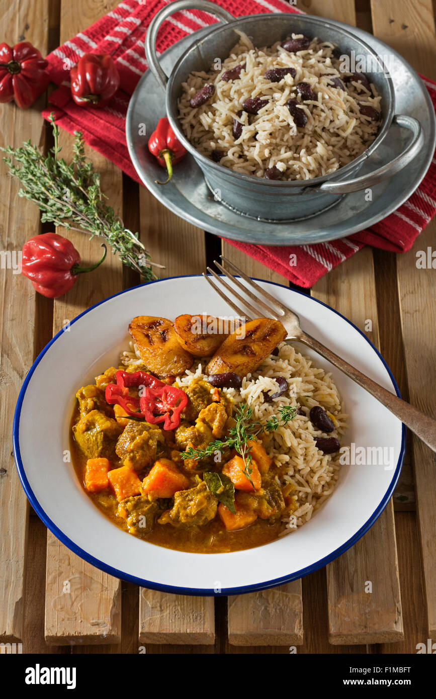 Caribbean curry goat with rice and peas. West Indies Food Stock Photo