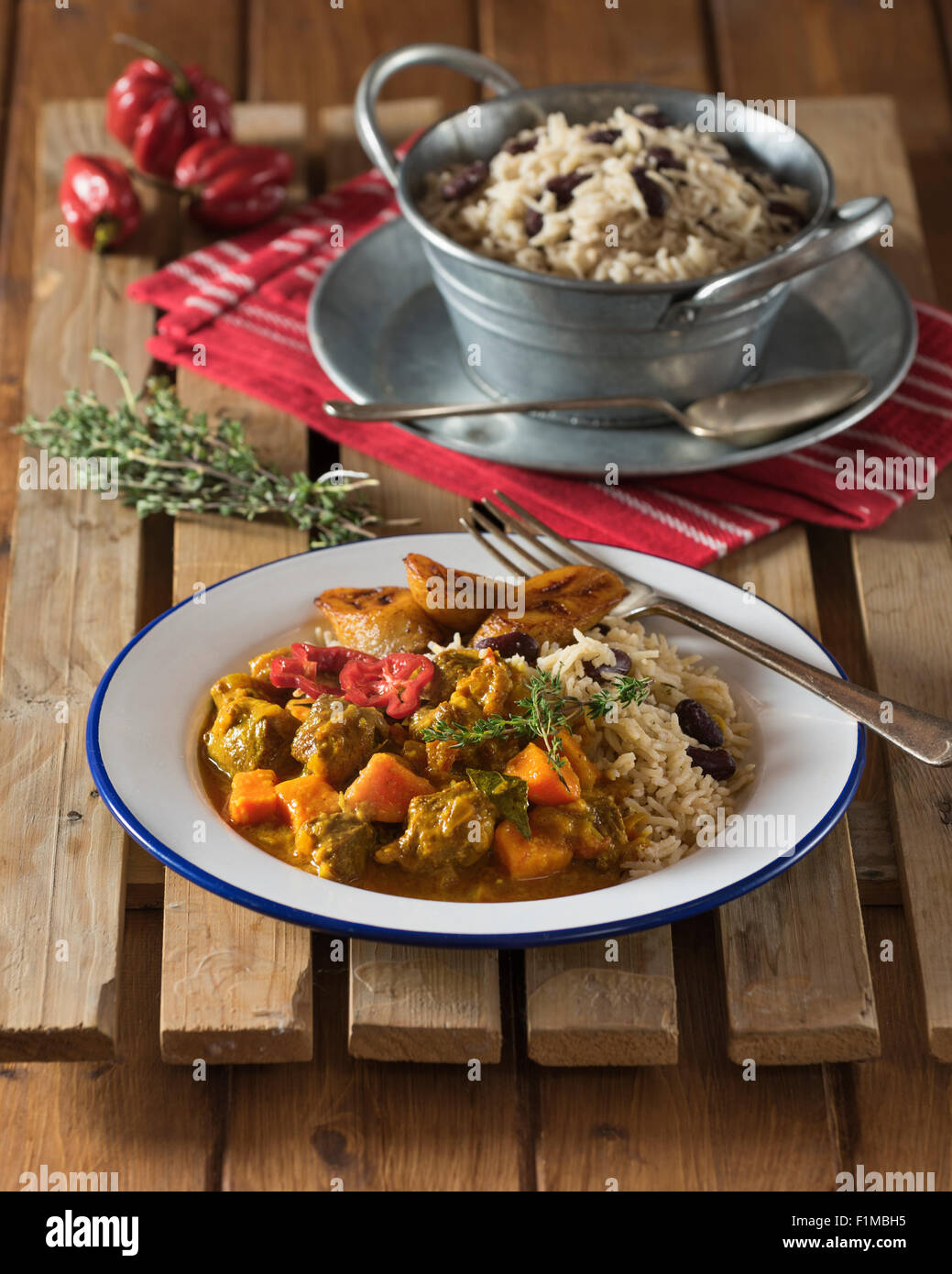 Caribbean curry goat with rice and peas. West Indies Food Stock Photo