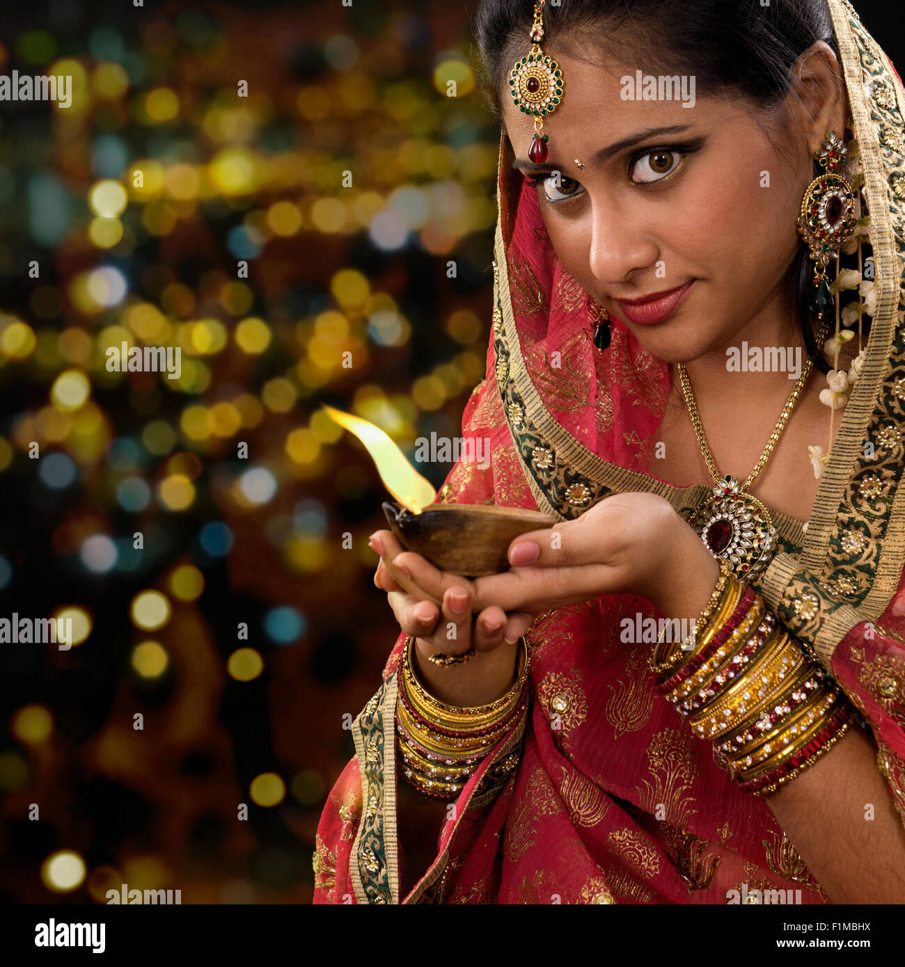 Indian woman lighting oil lamp hires stock photography and images Alamy