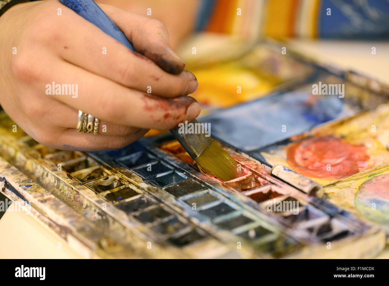 Artist with painting brush and artists color palette. Stock Photo