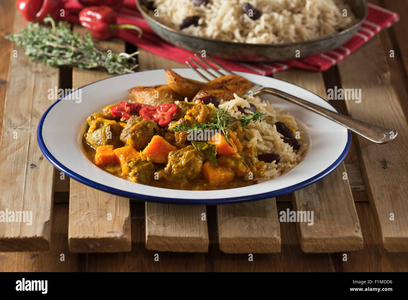 Caribbean curry goat with rice and peas. West Indies Food Stock Photo