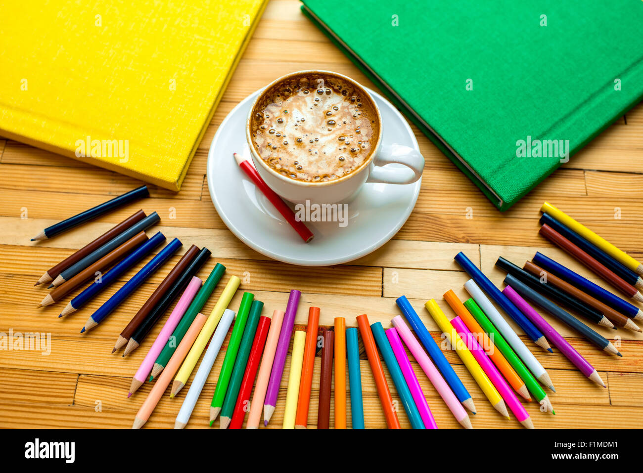 Colorful pencils with books and coffee Stock Photo