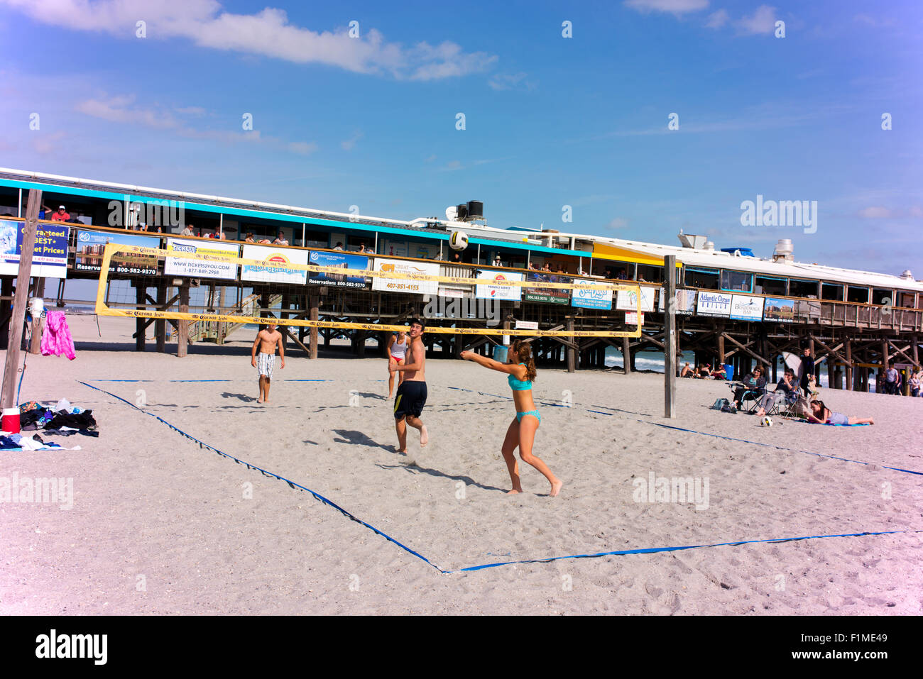 Young people playing volleyball on the beach in front of the Cocoa