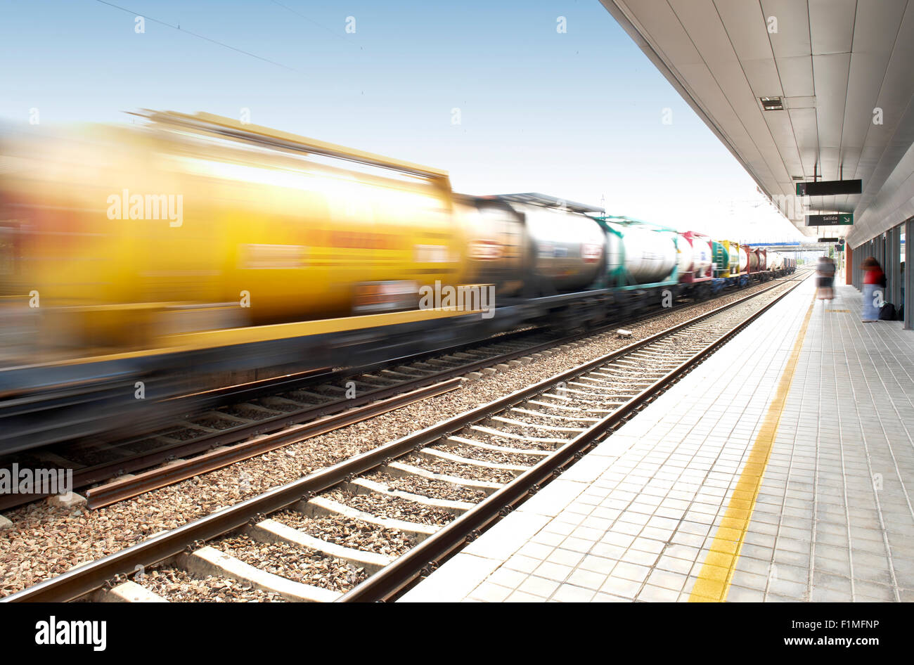 Freight train in movement on a railway station Stock Photo
