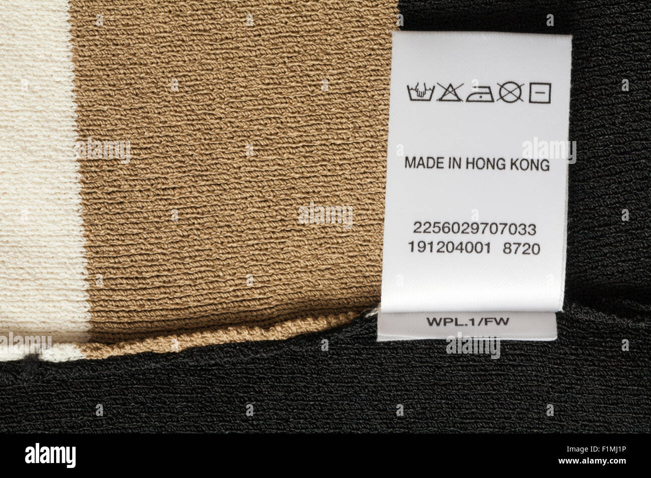 95% cotton 5% spandex label in woman's little black dress with beads made  in Hong Kong with wash care symbols and instructions Stock Photo - Alamy
