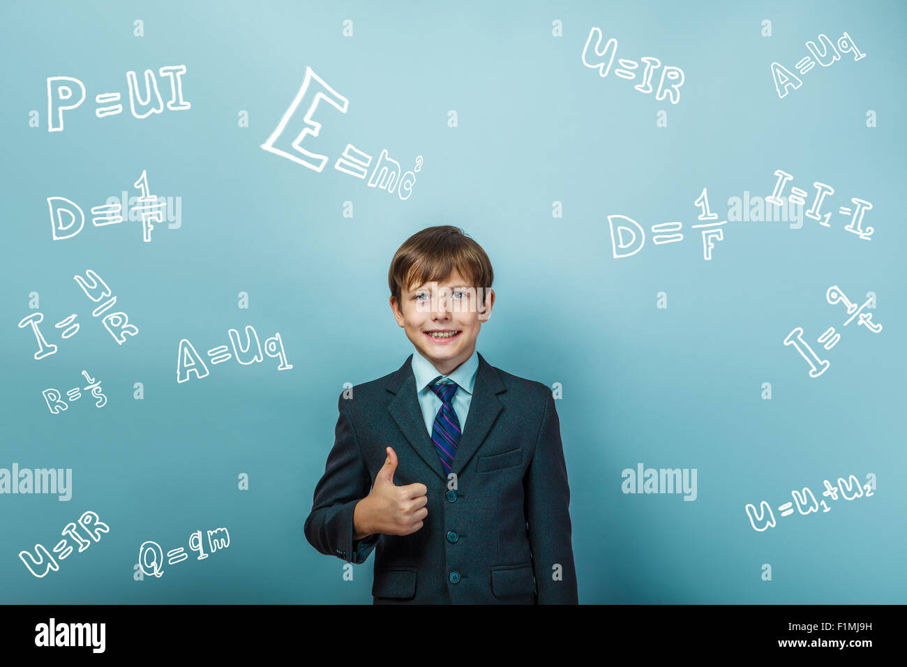a boy of twelve European appearance in a suit holding a blank sh Stock Photo