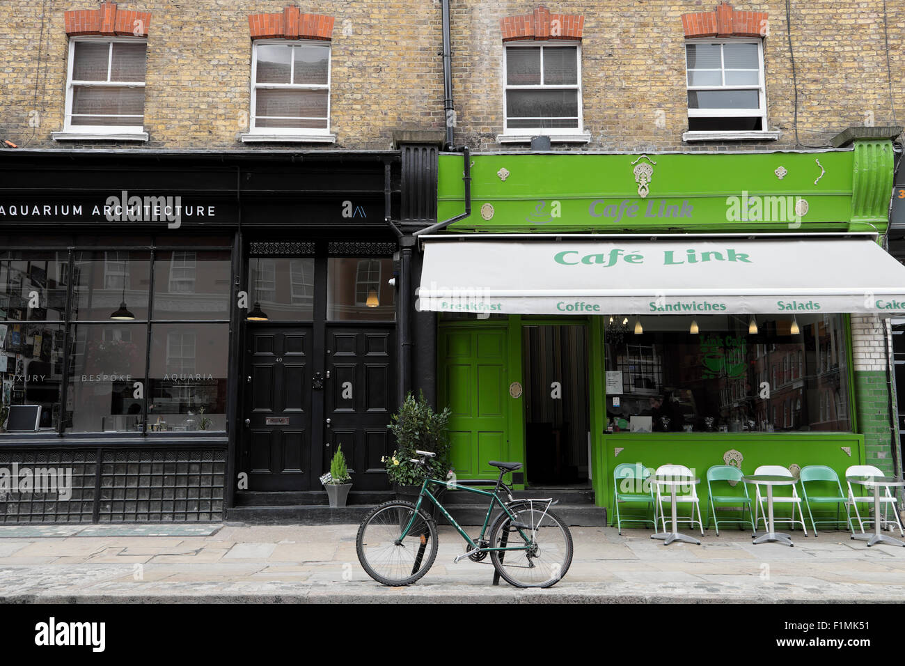 View bike parked outside Cafe Link and Aquarium Architecture on Snowsfields in Bermondsey South London UK  KATHY DEWITT Stock Photo