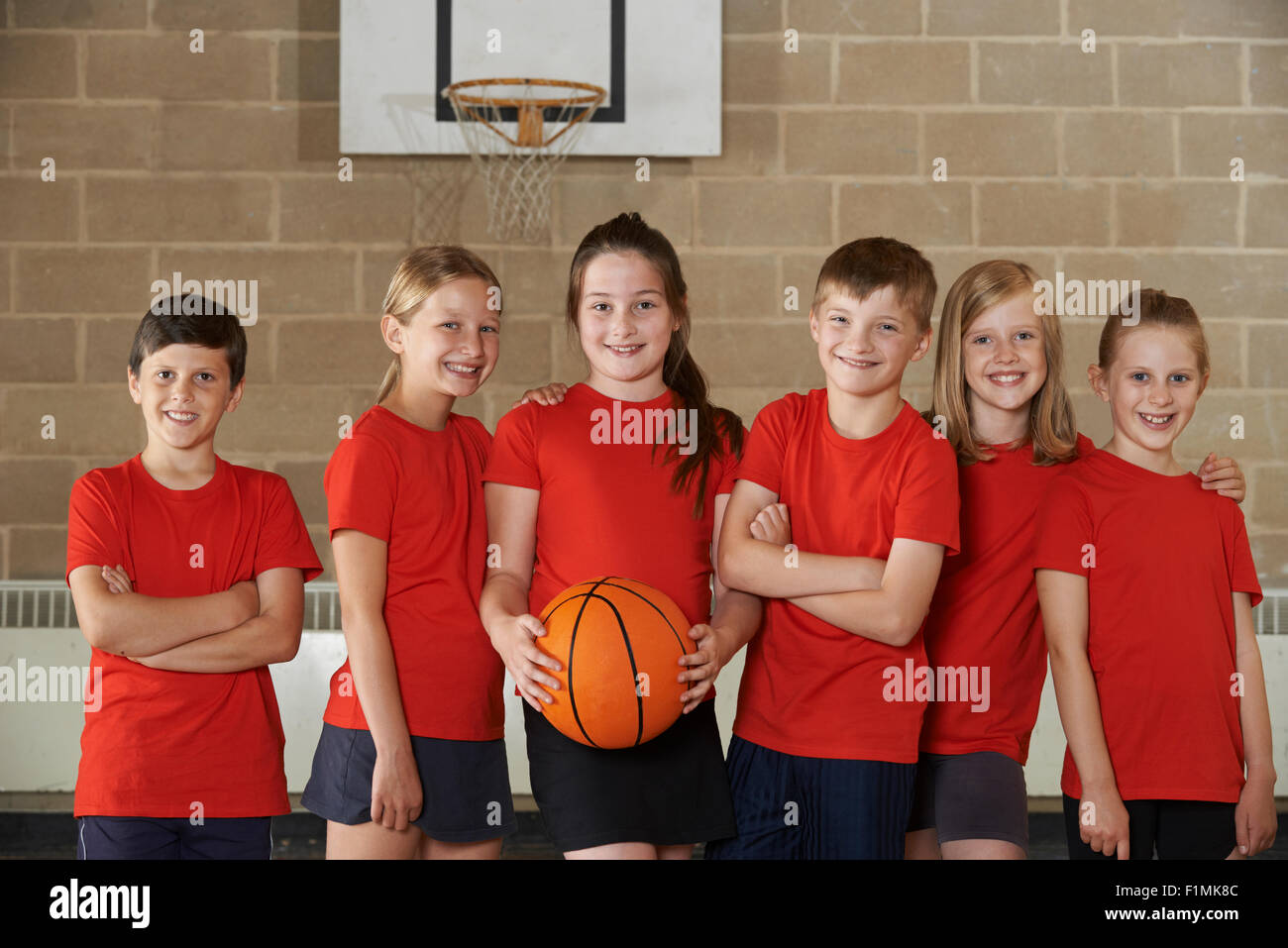 Portrait Of School Basketball Team In Gym Stock Photo