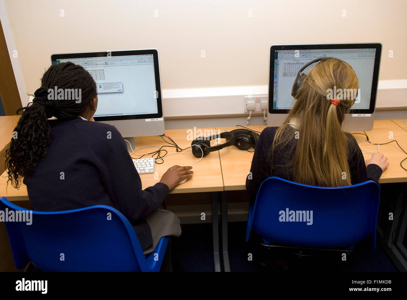 Primary school pupil's learning IT skills, London, UK. Stock Photo
