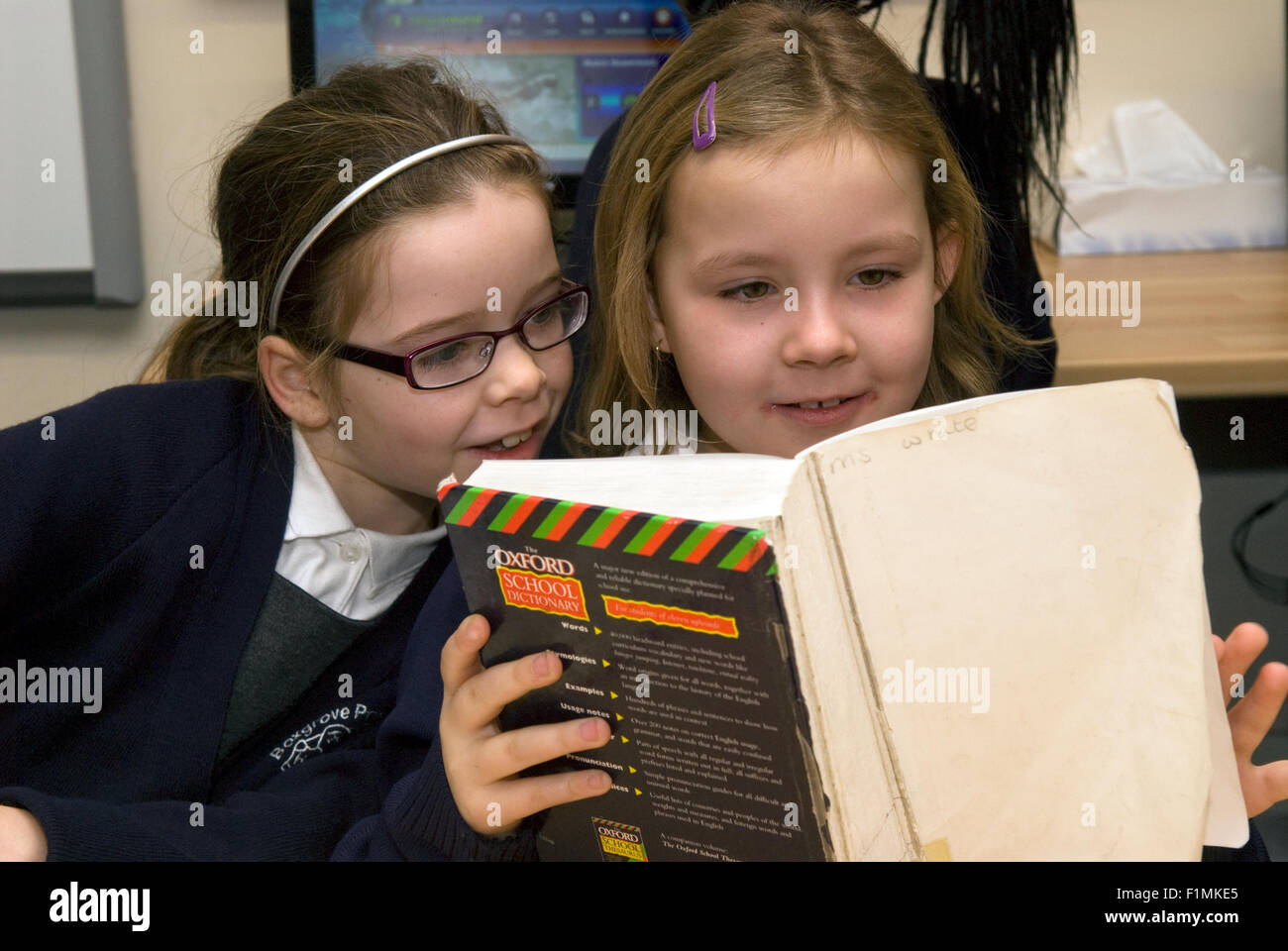 Primary school pupil's working together in English class, London, UK. Stock Photo