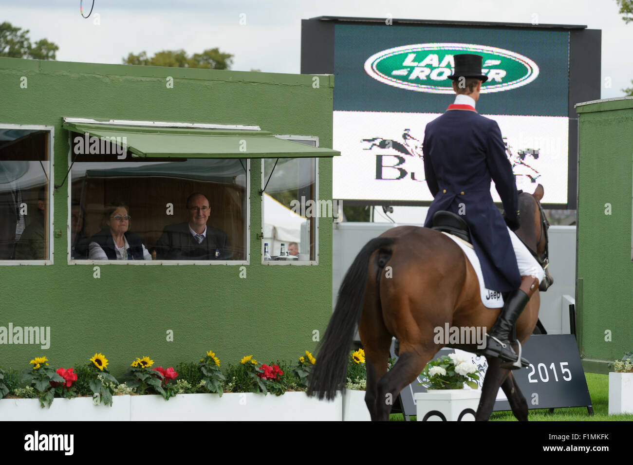 Burghley House, Stamford, UK, 4th September 2015. BBC Cricket Correspondent Jonathan Agnew watches William Fox-Pitt prepare for his dressage test at Burghley Horse Trials as he prepares for his role as commentator for the equestrian sports at the Rio Olympics. Credit:  Nico Morgan/Alamy Live News Stock Photo