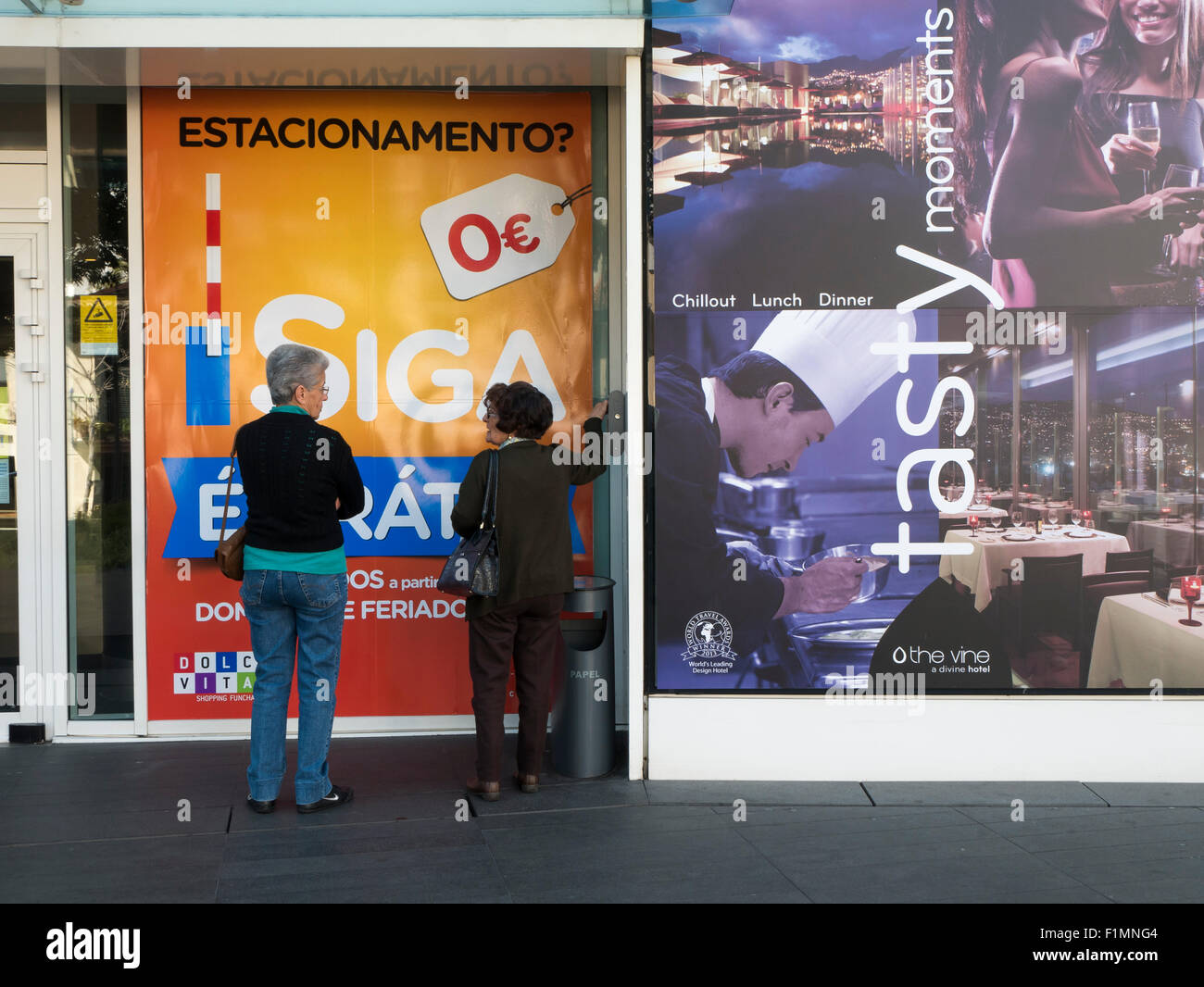 Ladies and Advertisement Hoarding, Funchal, Madeira, Portugal Stock Photo