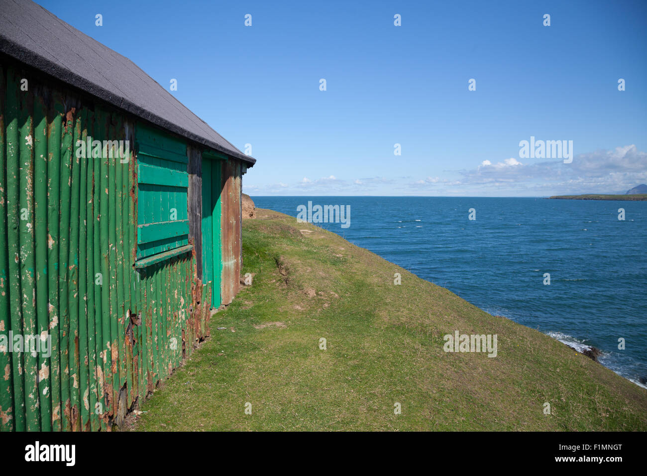 Close up of corrugated steel fishing hut perched on a clifftop above Porth Ysgaden, Tudweiliog, Llyn Peninsula, North Wales Stock Photo