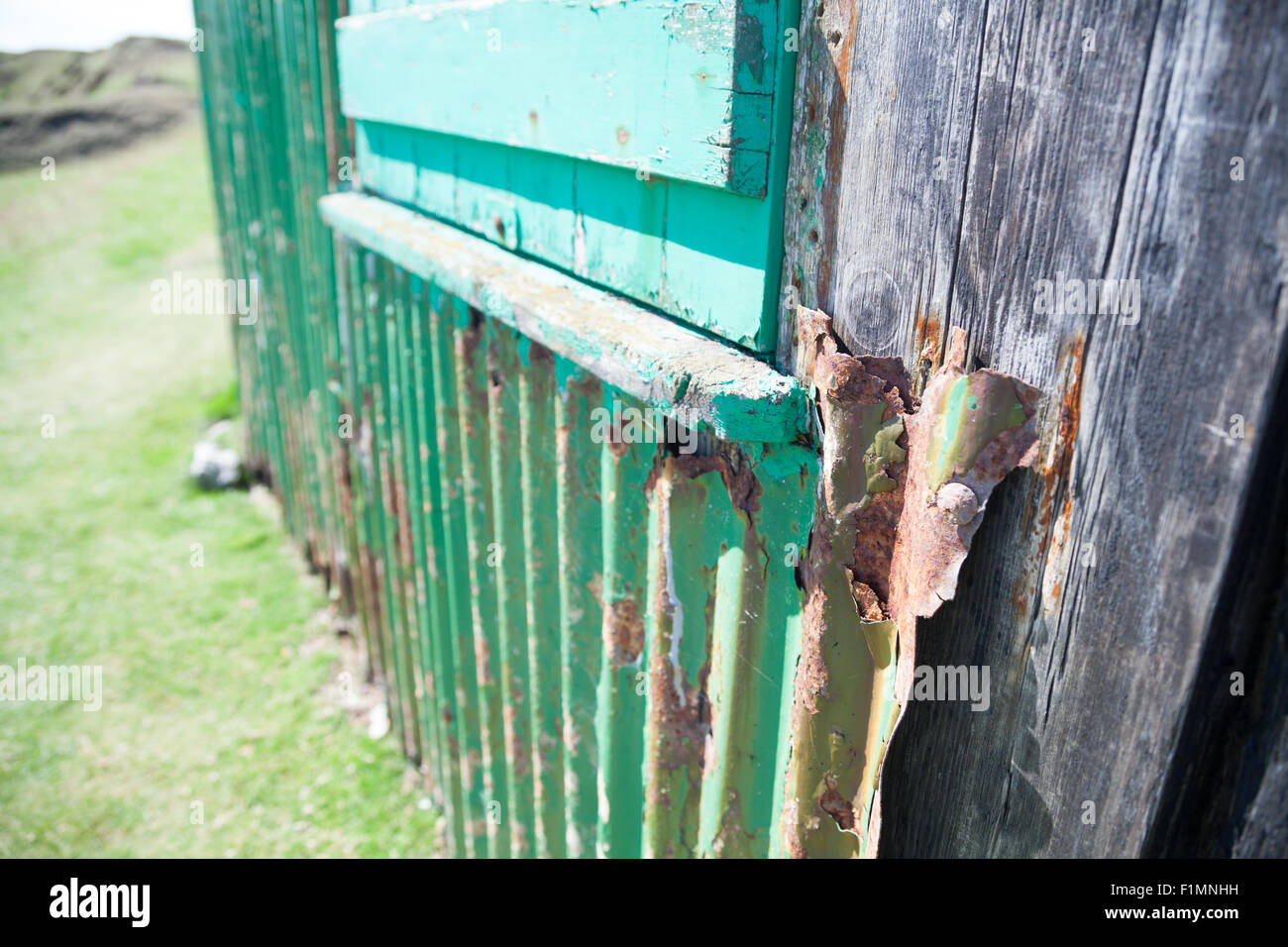 Close up of corrugated steel fishing hut perched on a clifftop above Porth Ysgaden, Tudweiliog, Llyn Peninsula, North Wales Stock Photo