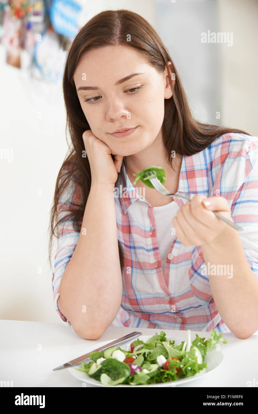 Teenage Girl On Diet Eating Plate Of Salad Stock Photo