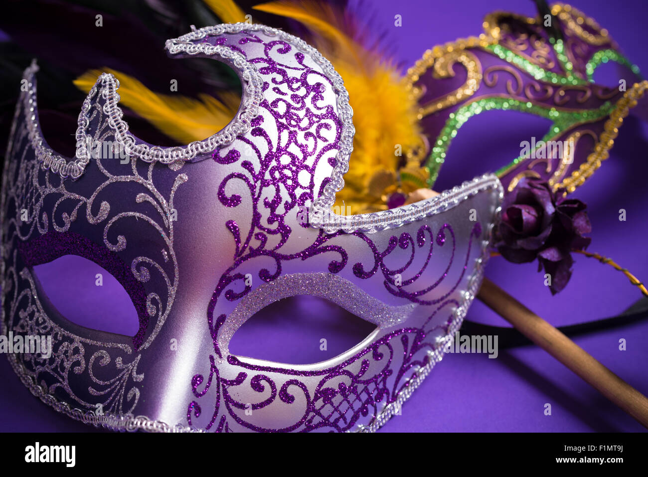 Mardi Gras or carnival mask on bright purple background Stock Photo - Alamy