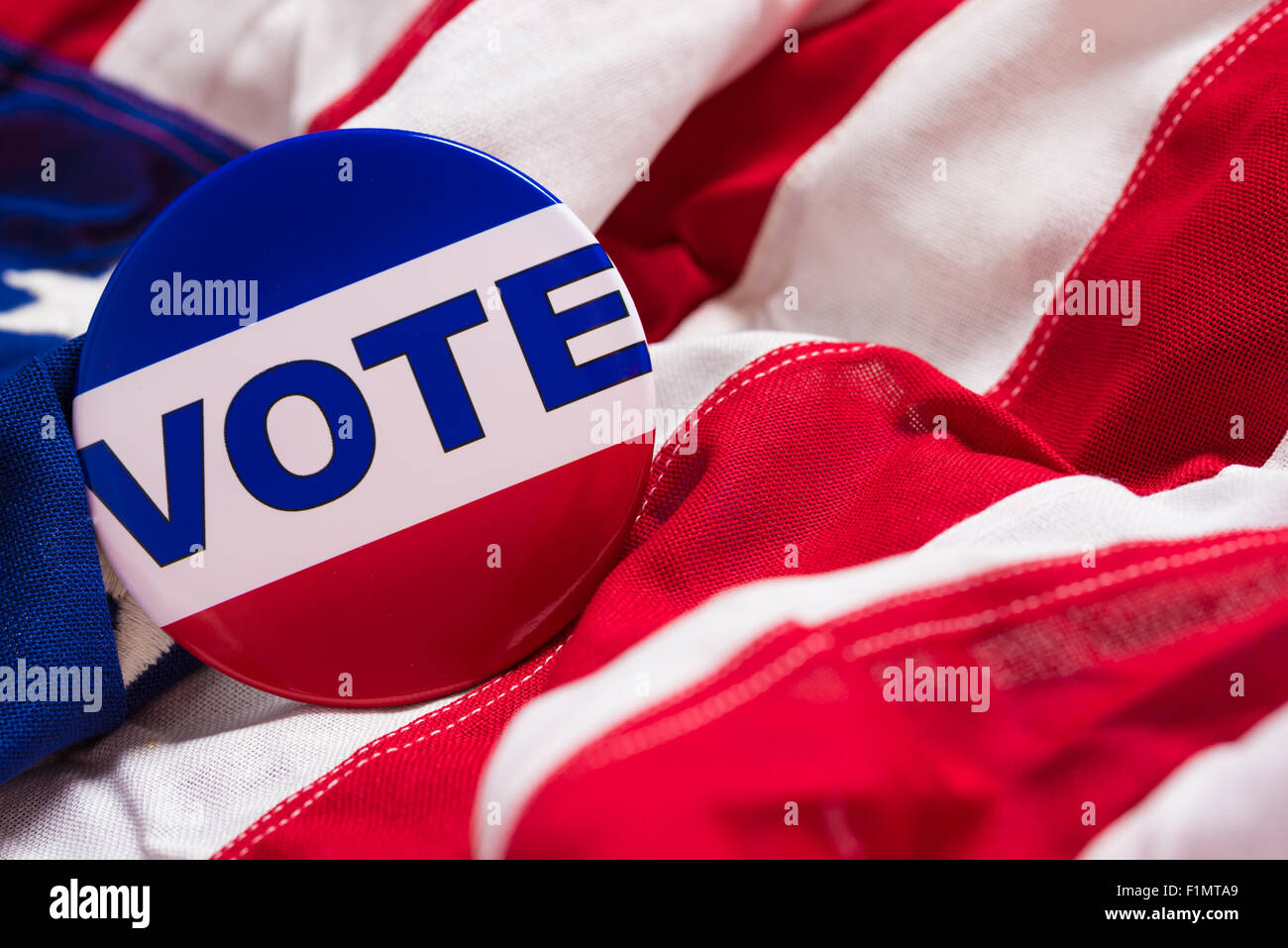 A 'VOTE' pin or button on a flag of the United States Stock Photo