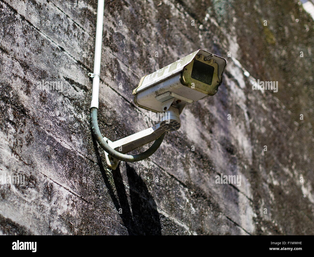 clappedout security camera on concrete wall Stock Photo Alamy