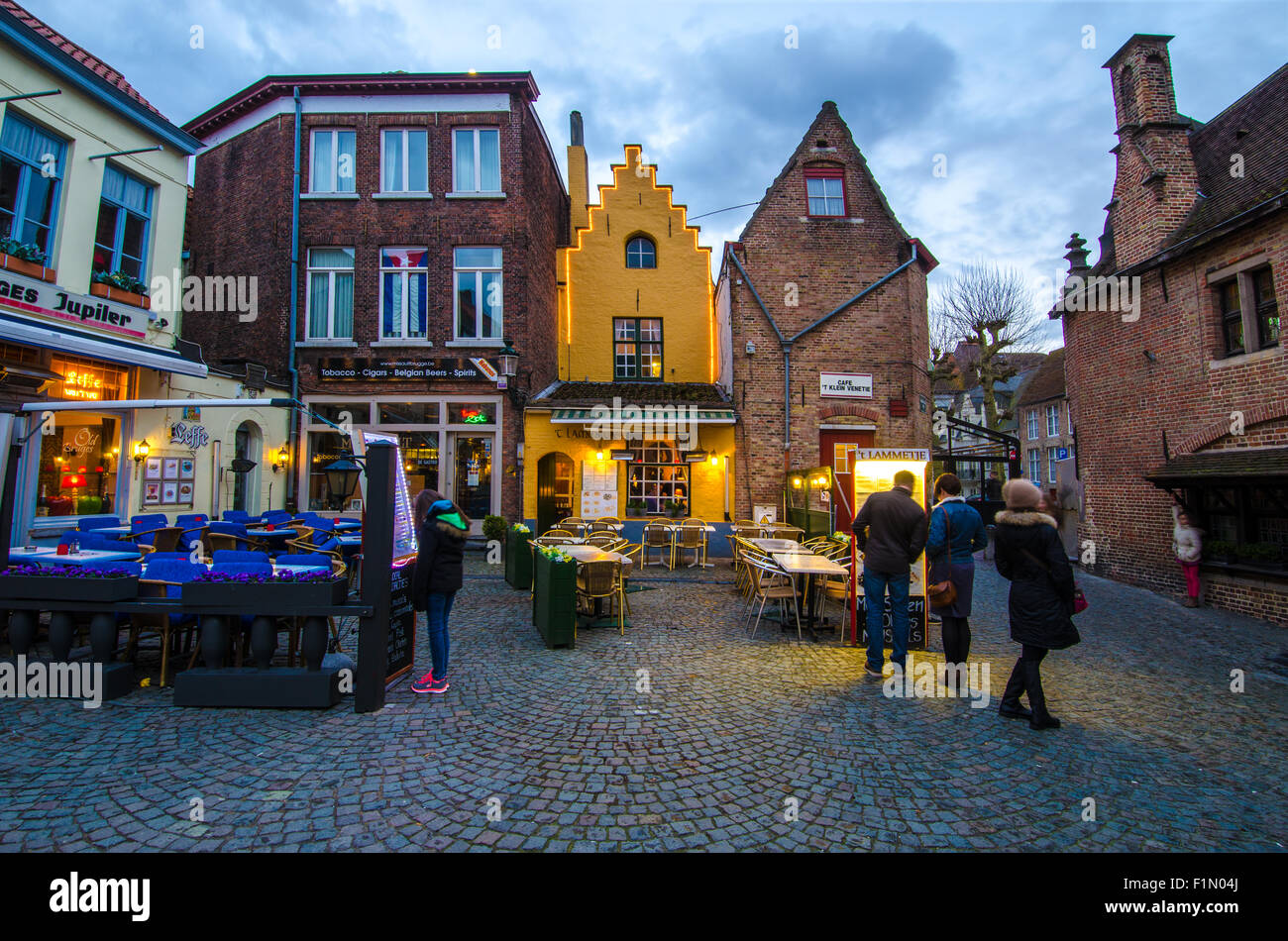 Some tourists deciding where to have dinner in Bruges. Stock Photo