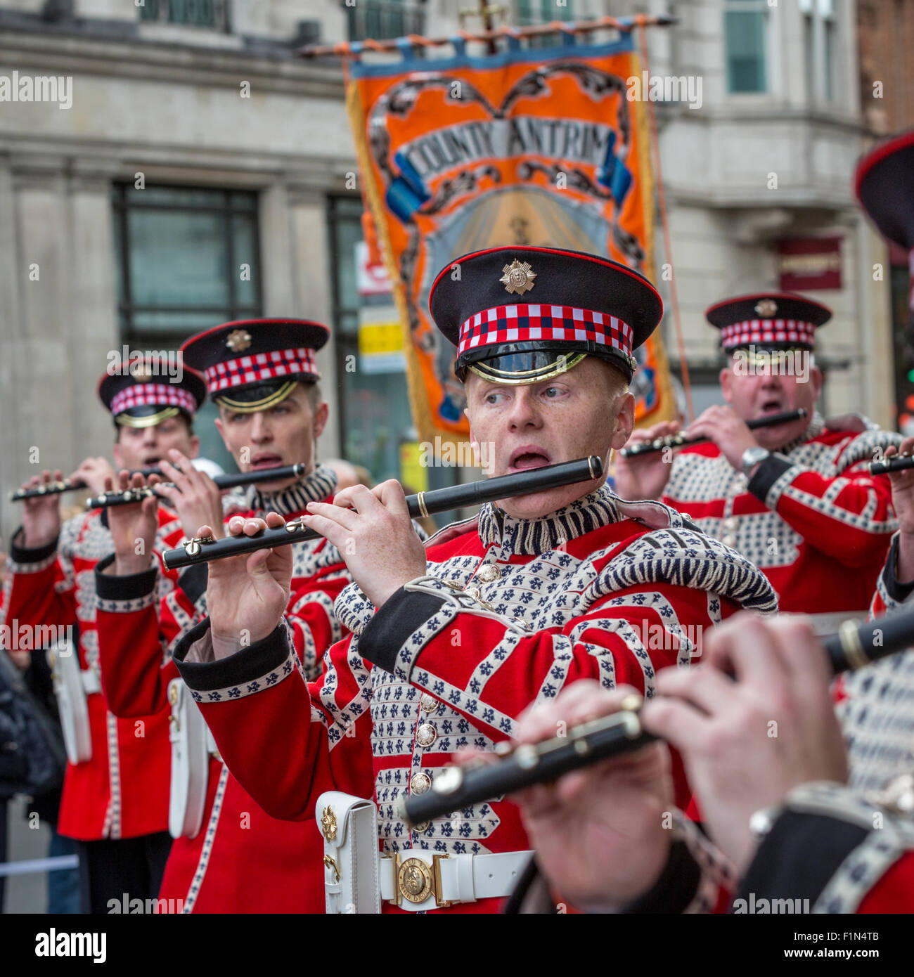 Red-clad Loyal Orange Lodge band marches through Trafalgar Square on the day of the Trooping of the Colours Stock Photo