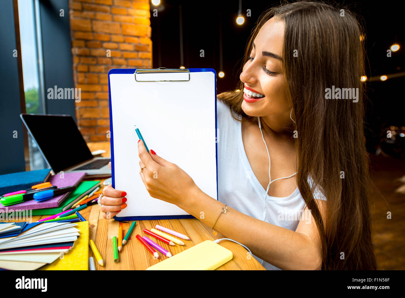 Woman showing board with white paper Stock Photo