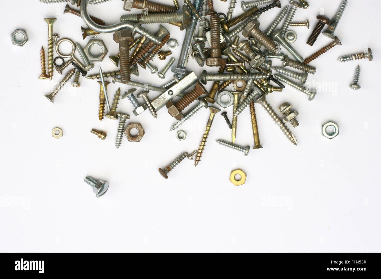 A pile of nuts,bolts, screws and other fasteners on a white background Stock Photo