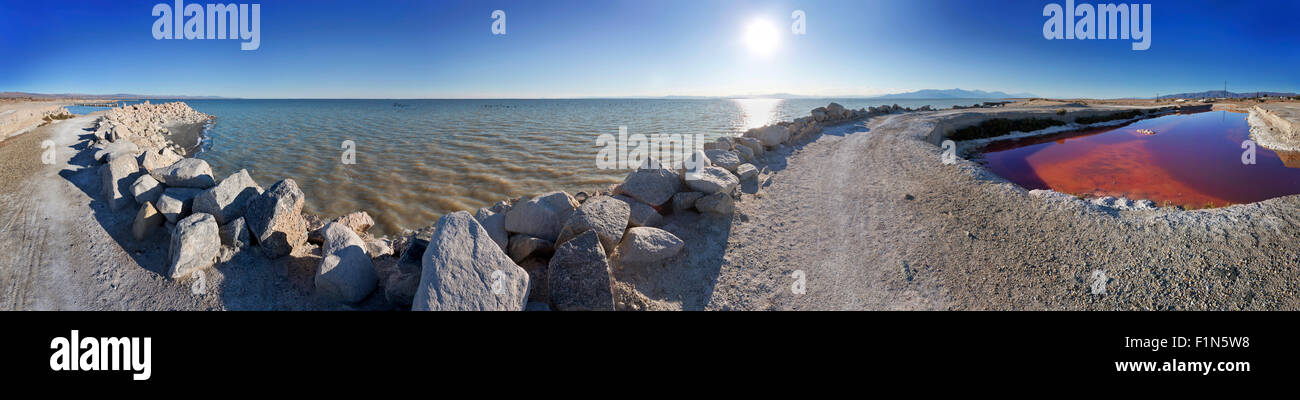 Panorama of the shoreline of the Salton Sea at Bombay Beach, California. Showing the inland sea and a pool of red algae. Stock Photo