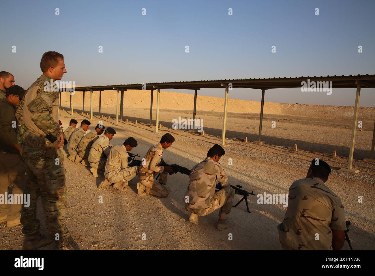 Iraqi army soldiers from the 75th Brigade learn how to use their new M240B machine guns during training September 4, 2015 at Al Asad Air Base, Iraq. Stock Photo