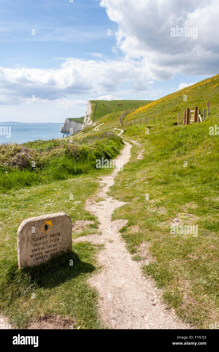 Stone marker on the coastal path at Durdle Door with distances to Swyre Head and White Nothe. Stock Photo