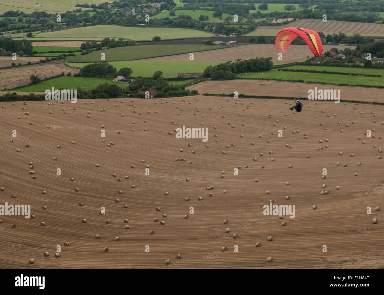 Firle Beacon, East Sussex, UK.4 September 2015.Overcast with a Northerly breeze make for good Paragliding conditions, if somewhat cooler, over the South Downs.. Stock Photo
