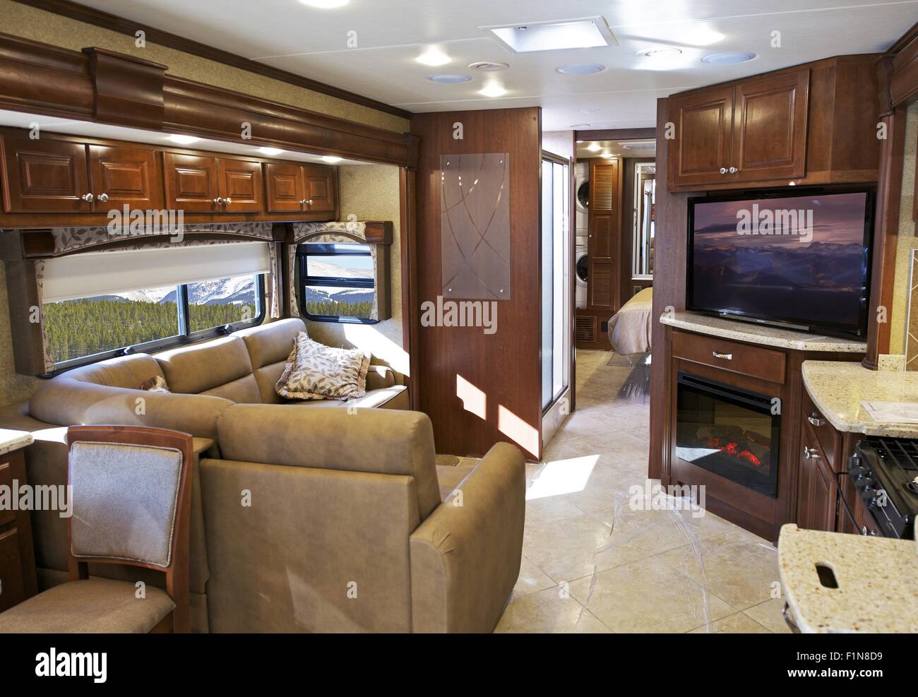Modern RV Interior. Class A Spacious and Luxury Interior with Large LED Television. Stock Photo