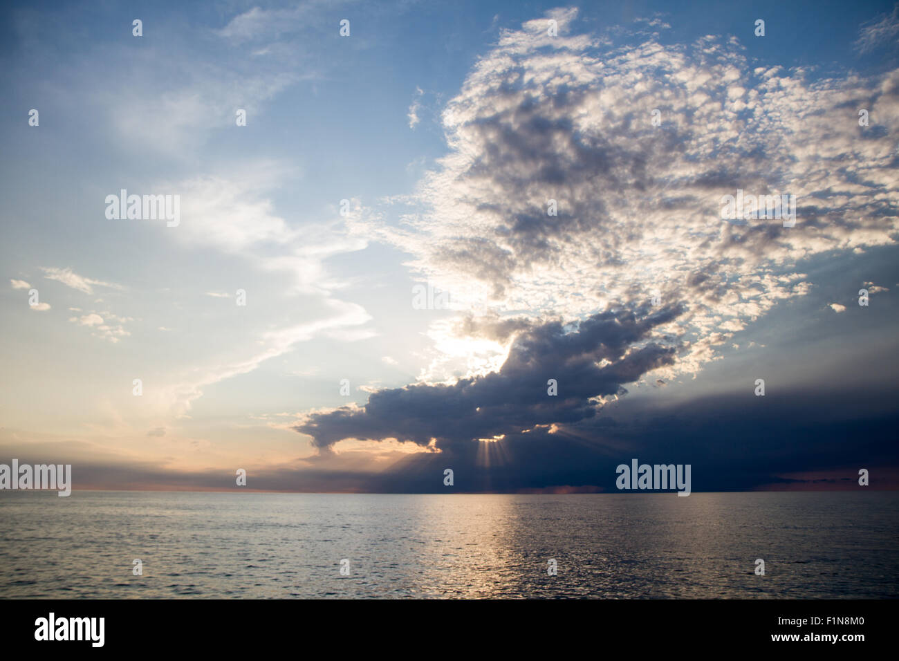 sunset over the sea! clouds and sun Stock Photo - Alamy