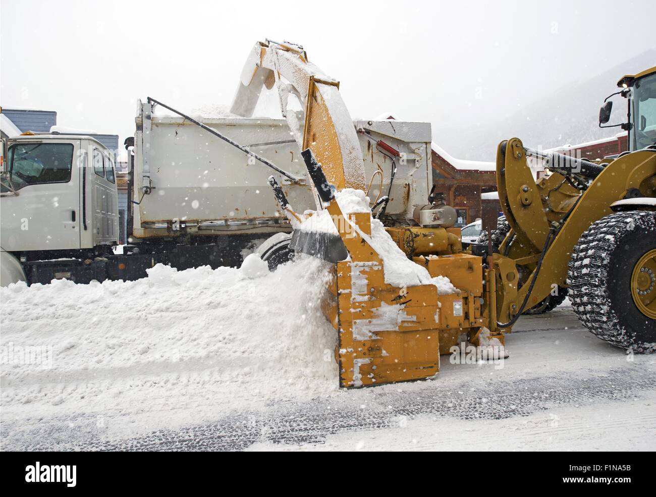 Street Snow Removal by Heavy Equipment. Colorado Snow Removal. Stock Photo