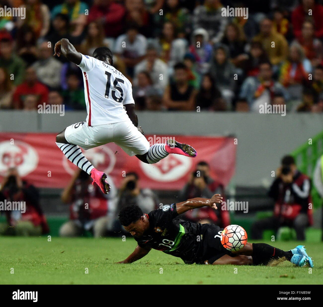 Lisbon, Portugal. 4th Sep, 2015. Bacary Sagna (Top) of France is tackled by Eliseu of Portugal during the Euro 2016 friendly football match in Lisbon, Portugal, Sept. 4, 2015. Portugal lost the match 0-1. Credit:  Zhang Liyun/Xinhua/Alamy Live News Stock Photo