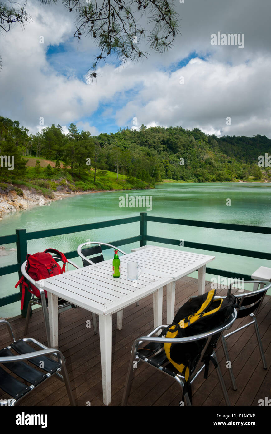 Two one-day packs and a bottle of beer at a cafe on the side of Lake Linow in Lahendong, South Tomohon, Tomohon, North Sulawesi, Indonesia. Stock Photo