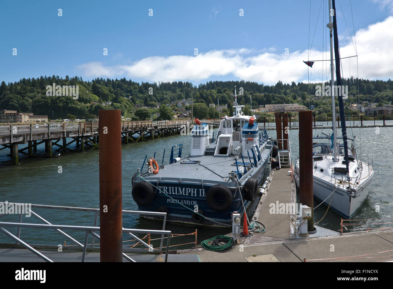 Tug boat and sail boat docked in Astoria Oregon. Stock Photo