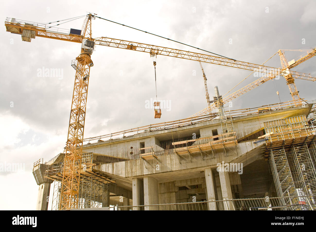 Construction site with crane on cloudy sky Stock Photo - Alamy