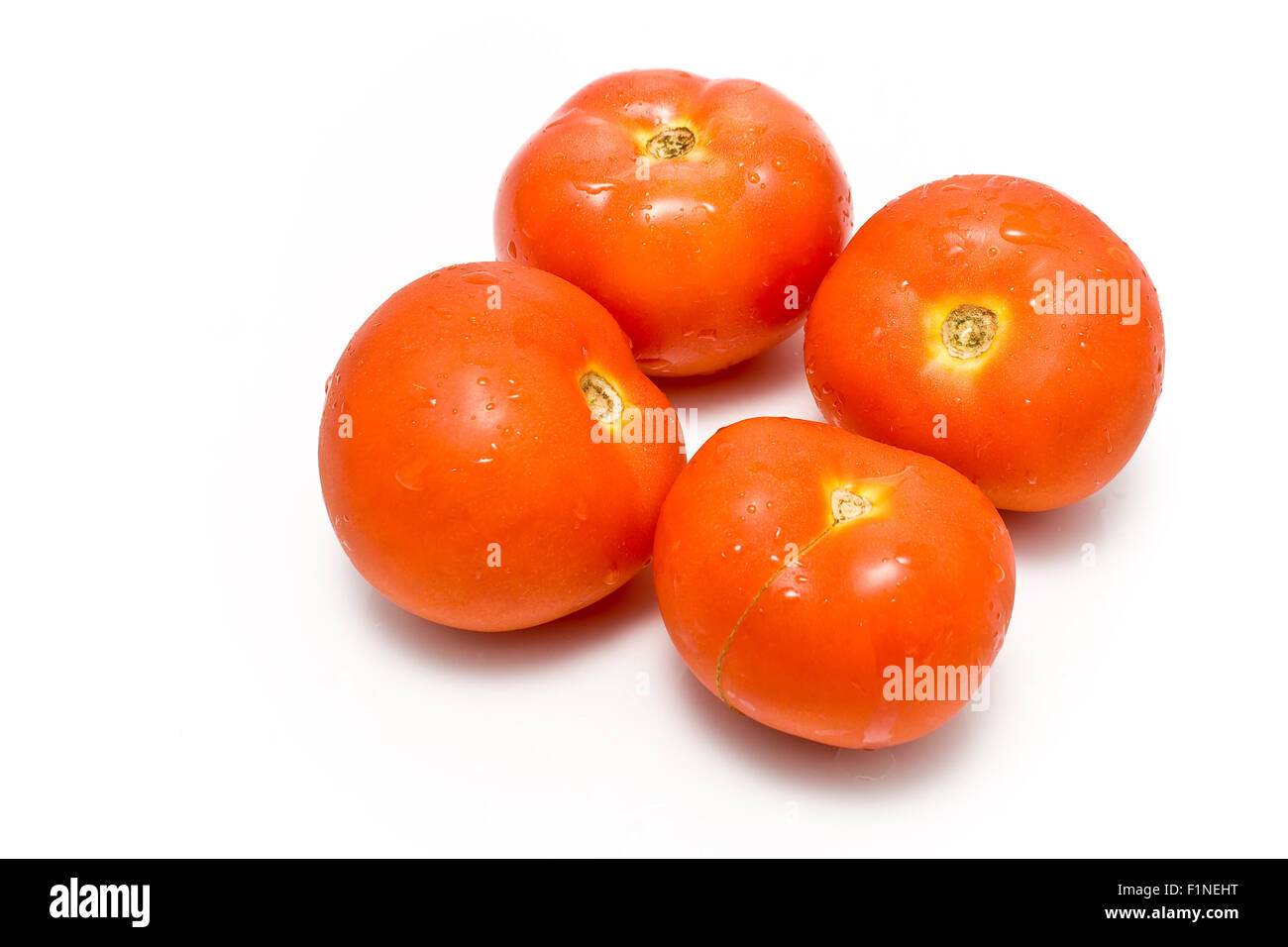 Four fresh tomatoes isolated on white Stock Photo