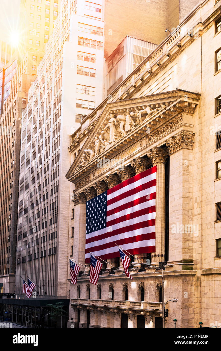 Famous Wall street and the building in New York, New York Stock Exchange with patriot flag Stock Photo