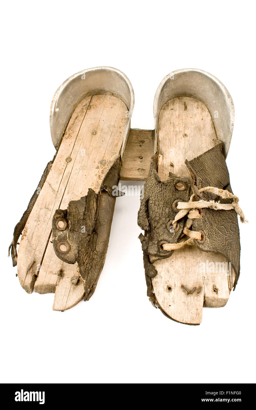 Very old  ski shoes isolated on white Stock Photo