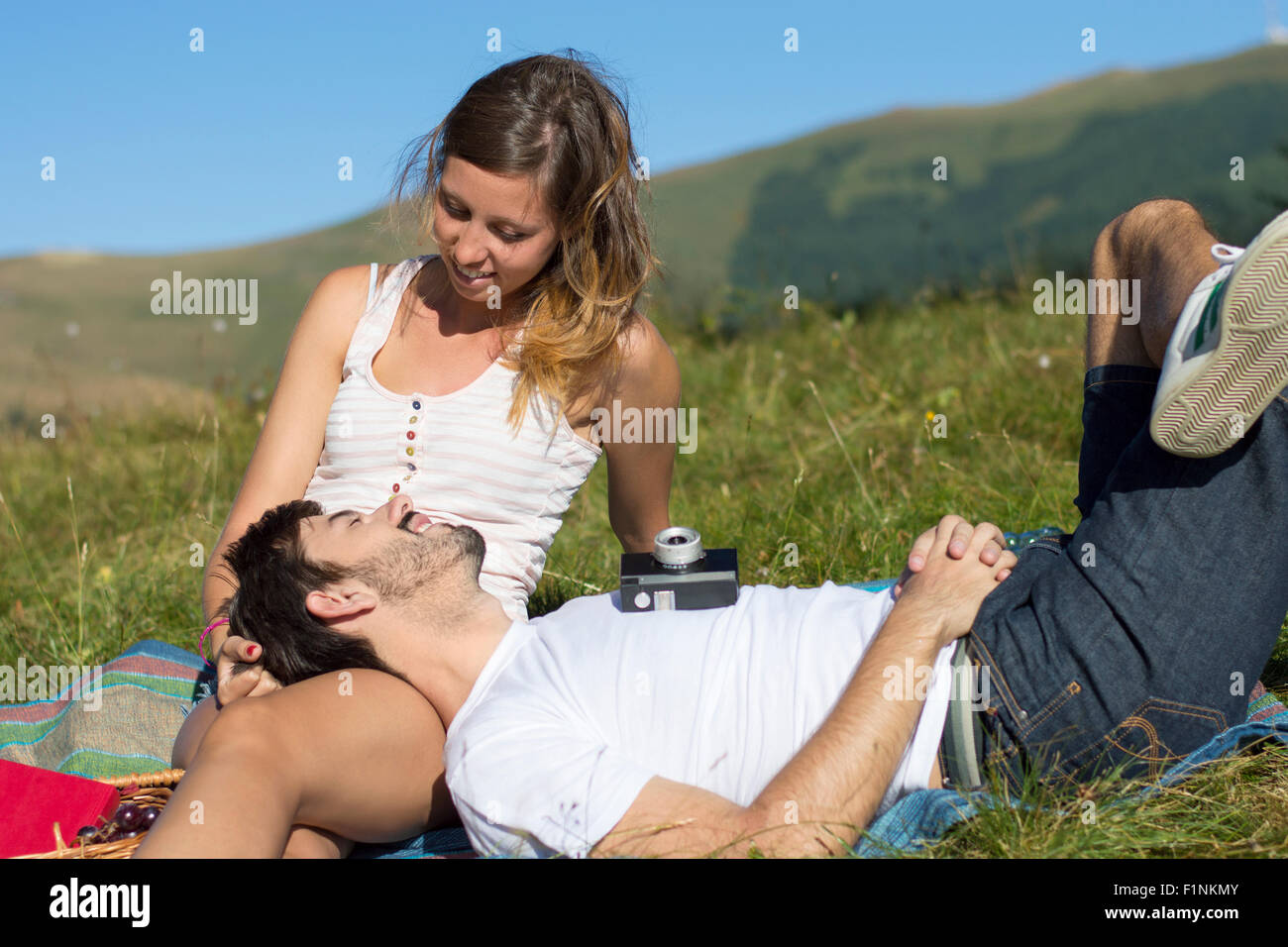 Loving couple out in the field expressing feelings. Outdoors date Stock Photo