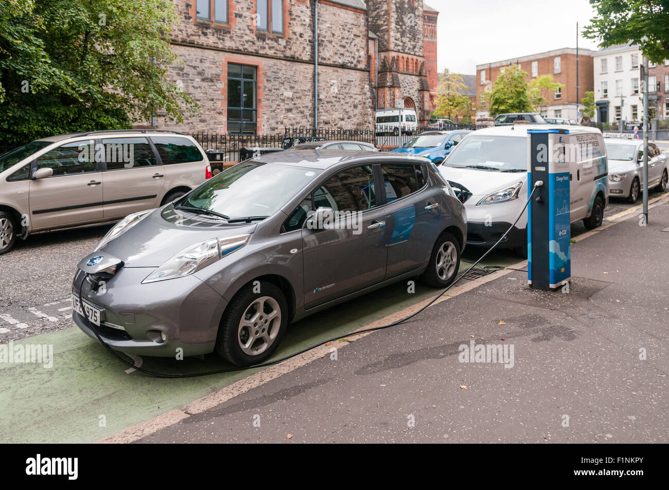 Nissan Leaf electric car charging at an on-street charging station. Stock Photo