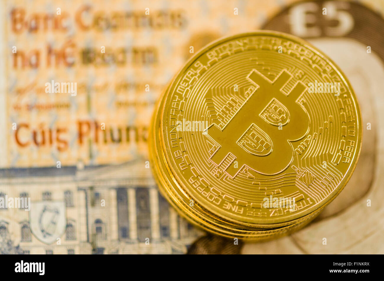 Bitcoins on an old Irish punt banknote Stock Photo