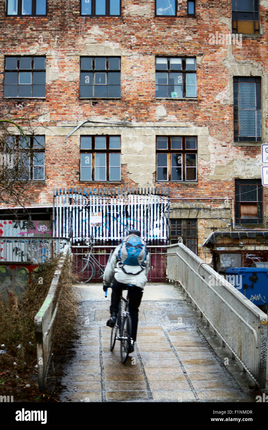 Europe; Germany; Berlin; Graffiti; Street art; Street; Building; House; Neighborhood; Boy; Man; Bridge; Bicycle; Cyclist; Straße Stock Photo